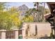 Beautiful desert landscaping with mountain views, mature trees, and decorative wall enhance the outdoor space at 6124 N 31St Ct, Phoenix, AZ 85016