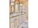 Bathroom featuring double sinks with granite countertops and decorative mirrors, offering a touch of luxury at 6124 N 31St Ct, Phoenix, AZ 85016