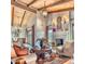 Living room with wood-beamed ceiling, fireplace, large windows, and elegant furniture creating a warm, inviting space at 6124 N 31St Ct, Phoenix, AZ 85016