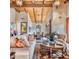 Spacious living room featuring wood-beamed ceilings, elegant decor, and seamless flow to the dining area at 6124 N 31St Ct, Phoenix, AZ 85016