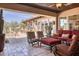 Inviting covered patio with comfortable seating, a fireplace, and views of the pool and backyard at 6124 N 31St Ct, Phoenix, AZ 85016