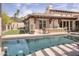 Stunning backyard featuring a sparkling pool, lush landscaping, and an outdoor kitchen area at 6124 N 31St Ct, Phoenix, AZ 85016