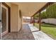 Covered outdoor patio with stone flooring and decorative lighting, leading to backyard at 6203 W Caribe Ln, Glendale, AZ 85306