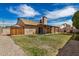 Backyard with covered patio and a grassy area perfect for outdoor activities at 6203 W Caribe Ln, Glendale, AZ 85306