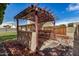 Backyard with a pergola, concrete pad and rocks at 6203 W Caribe Ln, Glendale, AZ 85306