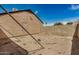 Large backyard featuring a block wall, desert landscaping and home exterior under a bright blue sky at 6203 W Caribe Ln, Glendale, AZ 85306