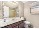 Bathroom with vanity and decorative mirror, along with a toilet and shower at 6203 W Caribe Ln, Glendale, AZ 85306
