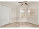 Bright dining area with large windows, tile flooring, and modern ceiling fan at 6203 W Caribe Ln, Glendale, AZ 85306