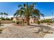 Single-story home with desert landscaping including palm trees and rock ground cover provides great curb appeal at 6203 W Caribe Ln, Glendale, AZ 85306