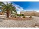 Desert landscaping featuring a bench, small shrubs and rock ground cover at 6203 W Caribe Ln, Glendale, AZ 85306