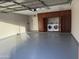 Spacious garage with epoxy floor and custom built-in cabinets, including washer and dryer hookups at 6203 W Caribe Ln, Glendale, AZ 85306