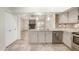 Open kitchen with granite countertops, stainless steel appliances and views into the living area at 6203 W Caribe Ln, Glendale, AZ 85306