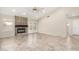 Spacious living room with tile flooring, fireplace, and double doors leading to the backyard at 6203 W Caribe Ln, Glendale, AZ 85306
