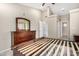 Main bedroom with hardwood furniture, tile floors, and a walk in closet at 6203 W Caribe Ln, Glendale, AZ 85306
