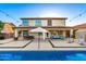 Beautiful backyard featuring a sparkling pool, spacious patio, outdoor seating, and meticulous landscaping at 6449 S Glory Ct, Gilbert, AZ 85298