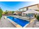 The backyard is showcased with its pool, patio furniture, and a covered outdoor dining area at 6449 S Glory Ct, Gilbert, AZ 85298