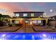 Gorgeous home with a pool, covered patio, and string lights creating a relaxing and inviting atmosphere at 6449 S Glory Ct, Gilbert, AZ 85298