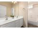 Bright bathroom featuring a double vanity and a separate room with a tub and shower at 6449 S Glory Ct, Gilbert, AZ 85298
