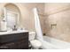 Bathroom with shower-tub combination, decorative tile, vanity sink and round mirror at 6449 S Glory Ct, Gilbert, AZ 85298