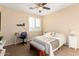 Cozy bedroom featuring a window with shutters, a ceiling fan, and a comfortable bed with stylish decor at 6449 S Glory Ct, Gilbert, AZ 85298
