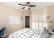 Well-lit bedroom featuring a closet, ceiling fan, and door to an adjoining room at 6449 S Glory Ct, Gilbert, AZ 85298