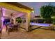View of a covered patio featuring a dining area and a stunning pool at 6449 S Glory Ct, Gilbert, AZ 85298
