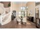 Bright dining room featuring tile floors, large windows with shutters, and elegant staircase at 6449 S Glory Ct, Gilbert, AZ 85298