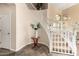 Home entryway featuring a wooden table, decorated staircase, and decorative tile flooring at 6449 S Glory Ct, Gilbert, AZ 85298