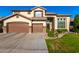 Charming two-story home featuring a three-car garage and perfectly manicured landscaping at 6449 S Glory Ct, Gilbert, AZ 85298