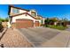 Lovely two-story home with a three-car garage and a spacious driveway for ample parking at 6449 S Glory Ct, Gilbert, AZ 85298