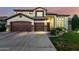 Charming two-story home boasts a three-car garage and meticulous landscaping, enhancing curb appeal at 6449 S Glory Ct, Gilbert, AZ 85298