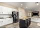 Spacious kitchen with stainless steel refrigerator, granite countertops, tile floors, and island with seating at 6449 S Glory Ct, Gilbert, AZ 85298