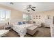 Bright main bedroom with neutral colors, white furniture, ceiling fan, and shuttered windows at 6449 S Glory Ct, Gilbert, AZ 85298