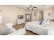 Main bedroom with neutral tones, white dresser, ceiling fan, and cozy white seating area at 6449 S Glory Ct, Gilbert, AZ 85298
