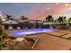 A luxurious pool area is showcased with lounge chairs, patio umbrellas, and decorative string lights at 6449 S Glory Ct, Gilbert, AZ 85298
