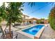 Stunning pool is showcased with a serene waterfall feature and lush landscaping at 6449 S Glory Ct, Gilbert, AZ 85298