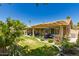 Expansive backyard with covered patio, lush landscaping, and well-maintained lawn at 7185 W Kimberly Way, Glendale, AZ 85308