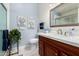 Cozy bathroom featuring a wood vanity with a marble countertop, and decorative artwork at 7185 W Kimberly Way, Glendale, AZ 85308
