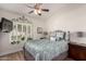 Comfortable bedroom with a ceiling fan, natural light, and wood-look flooring at 7185 W Kimberly Way, Glendale, AZ 85308