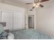 Comfortable bedroom with ceiling fan, sliding closet doors, and doorway leading to bathroom at 7185 W Kimberly Way, Glendale, AZ 85308
