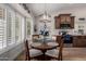 Charming dining area with a wooden table, plantation shutters, and adjacent kitchen access at 7185 W Kimberly Way, Glendale, AZ 85308