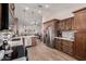 An airy kitchen featuring stainless appliances, custom wood cabinetry, a large counter, and an open floor plan at 7185 W Kimberly Way, Glendale, AZ 85308