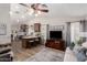Open-concept living room with hardwood floors, a modern kitchen island, and ample natural light at 7185 W Kimberly Way, Glendale, AZ 85308
