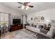 Cozy living room with hardwood floors, a comfortable sofa, and a wall-mounted television at 7185 W Kimberly Way, Glendale, AZ 85308