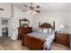 Comfortable main bedroom featuring beautiful wood furniture, a vaulted ceiling, and a ceiling fan at 7185 W Kimberly Way, Glendale, AZ 85308