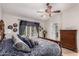 Comfortable main bedroom featuring beautiful wood furniture, a vaulted ceiling, and a ceiling fan at 7185 W Kimberly Way, Glendale, AZ 85308