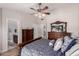Comfortable main bedroom featuring beautiful wood furniture, a vaulted ceiling, and multiple closets at 7185 W Kimberly Way, Glendale, AZ 85308