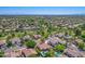 Expansive aerial view of a residential community with tree-lined streets and houses featuring private pools at 7236 W Aurora Dr, Glendale, AZ 85308