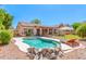 Expansive backyard with pool, fire pit, lounge chairs, and a covered patio, perfect for outdoor entertaining at 7236 W Aurora Dr, Glendale, AZ 85308