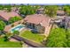 Overhead shot of a home's backyard with a pool, patio area, manicured lawn, and privacy fence at 7236 W Aurora Dr, Glendale, AZ 85308